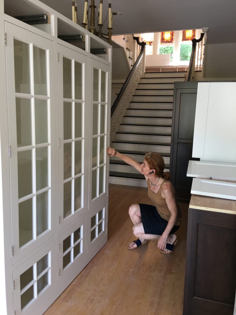 woman inspecting cabinets