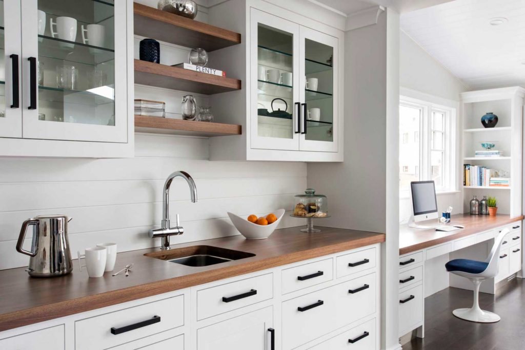 white kitchen bar with sink shelves and cabinets