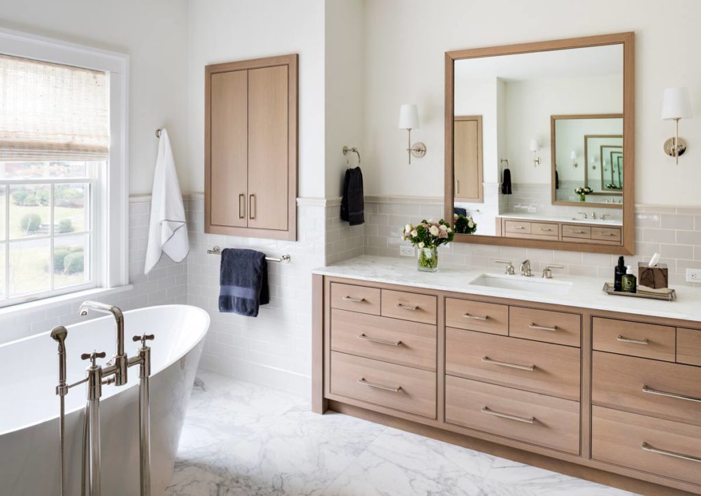 master bath with soaking tub and vanities