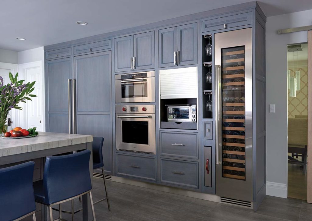 blue kitchen with wall of appliances