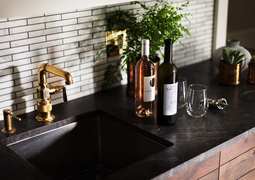 wood bar with brass details and dark countertop