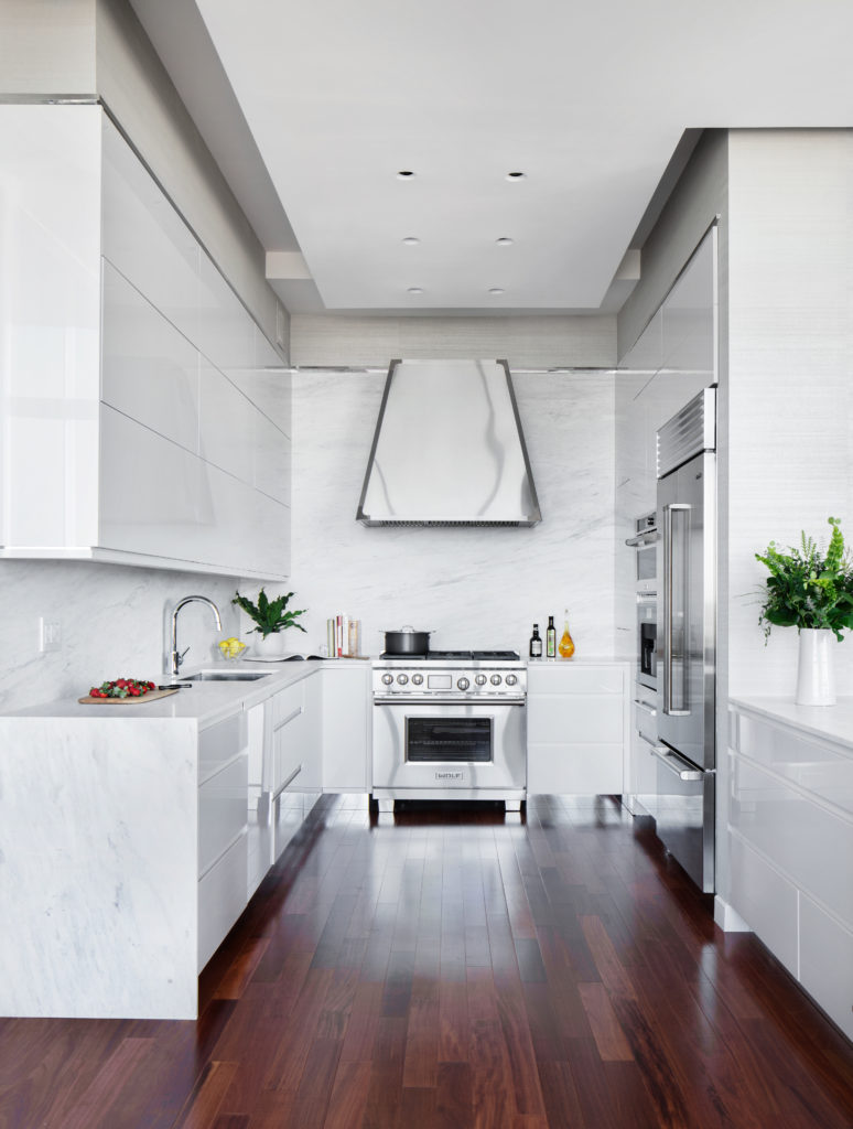 sleek stainless hood in marble kitchen