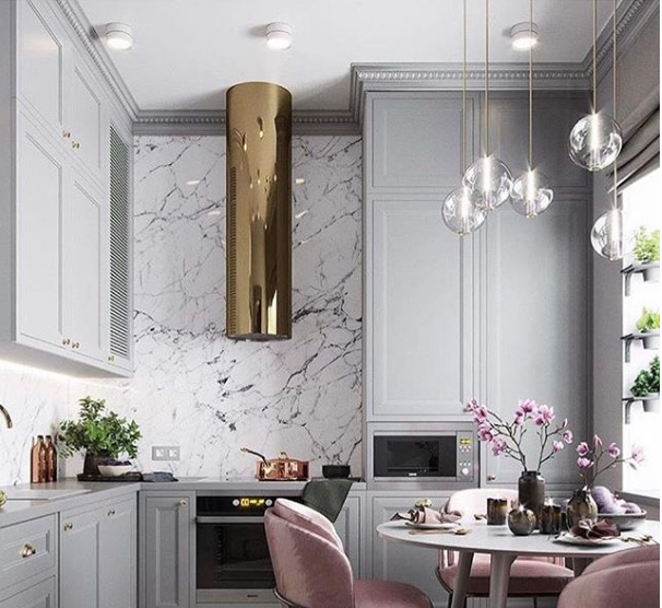 marble kitchen with gold cylinder hood