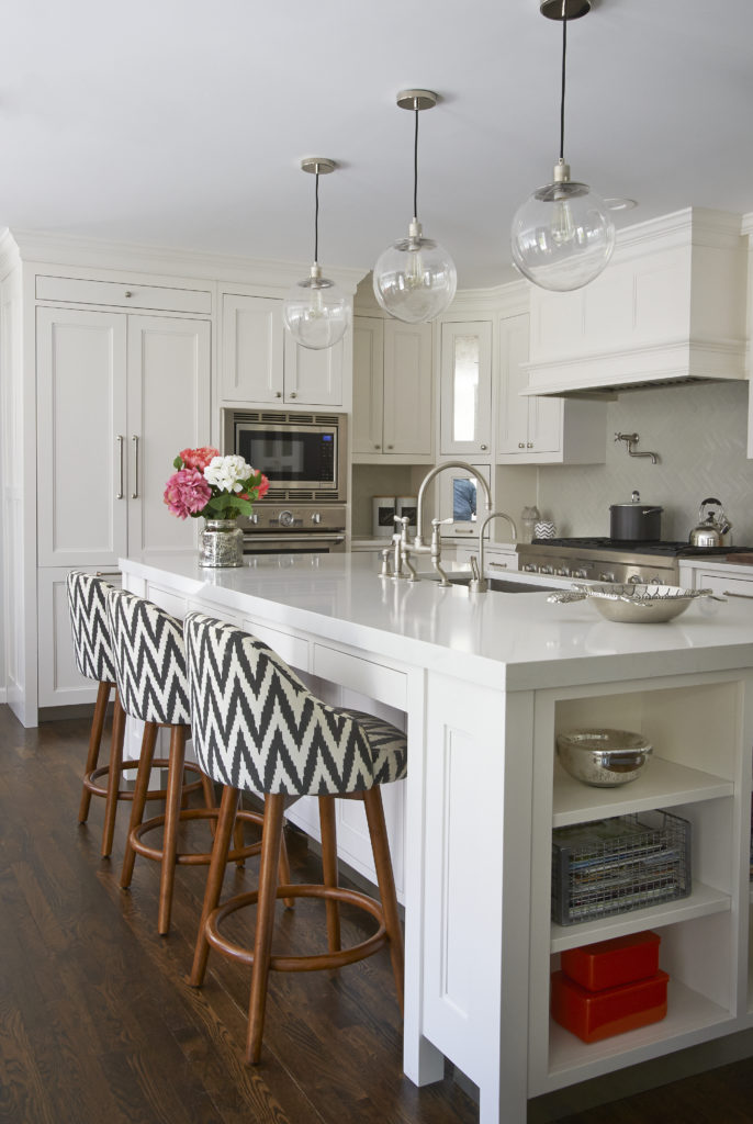 white kitchen island with chevron chairs