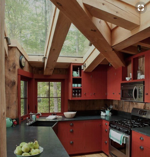 red kitchen with rustic beams