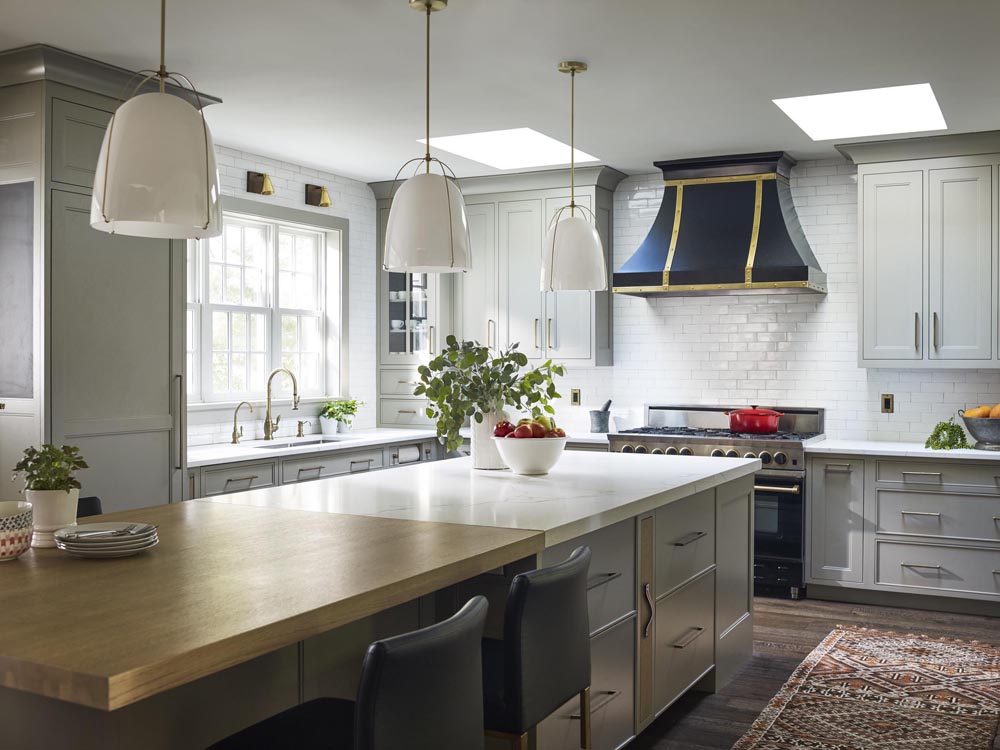 gray and white kitchen with large range hood