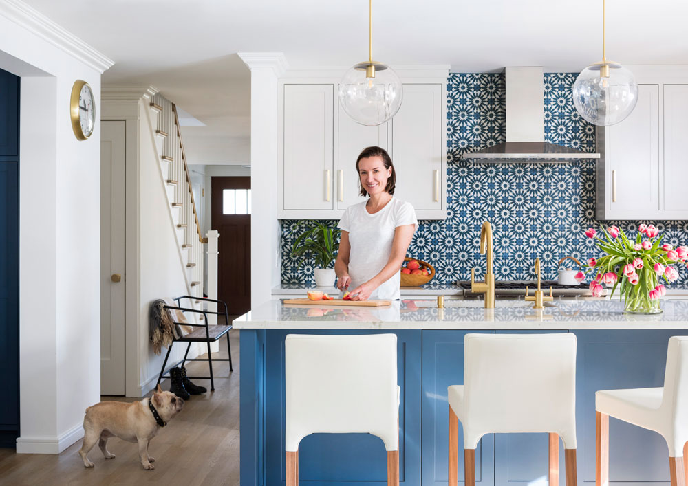woman and dog in blue and white kitchen