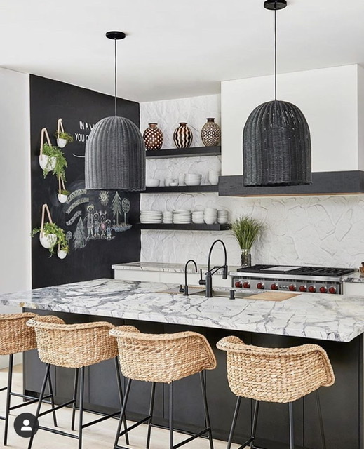 black and white kitchen with wicker stools and pendant lights