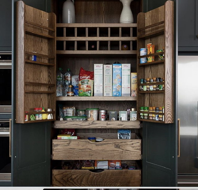 inside a wood pantry with shelves and storage items