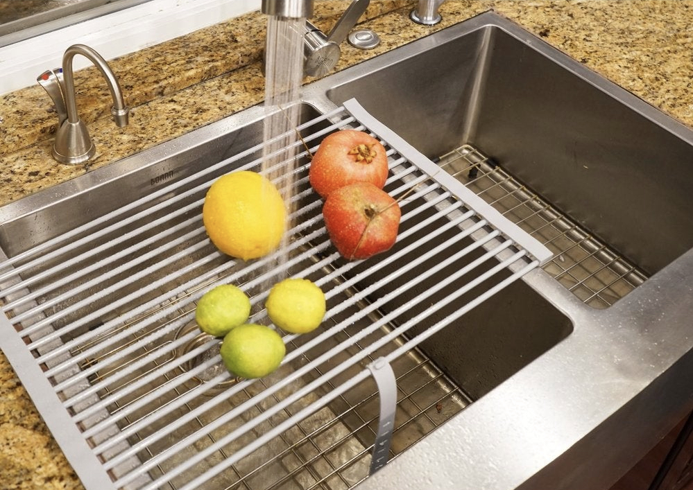 drying rack in sink with fruit and vegetables