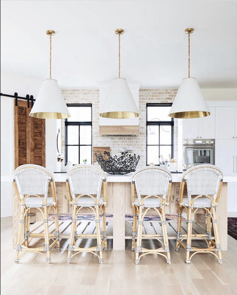white kitchen with woven stools at the island