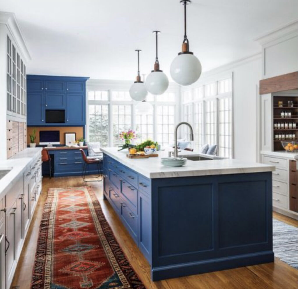 blue and white kitchen with island and desk