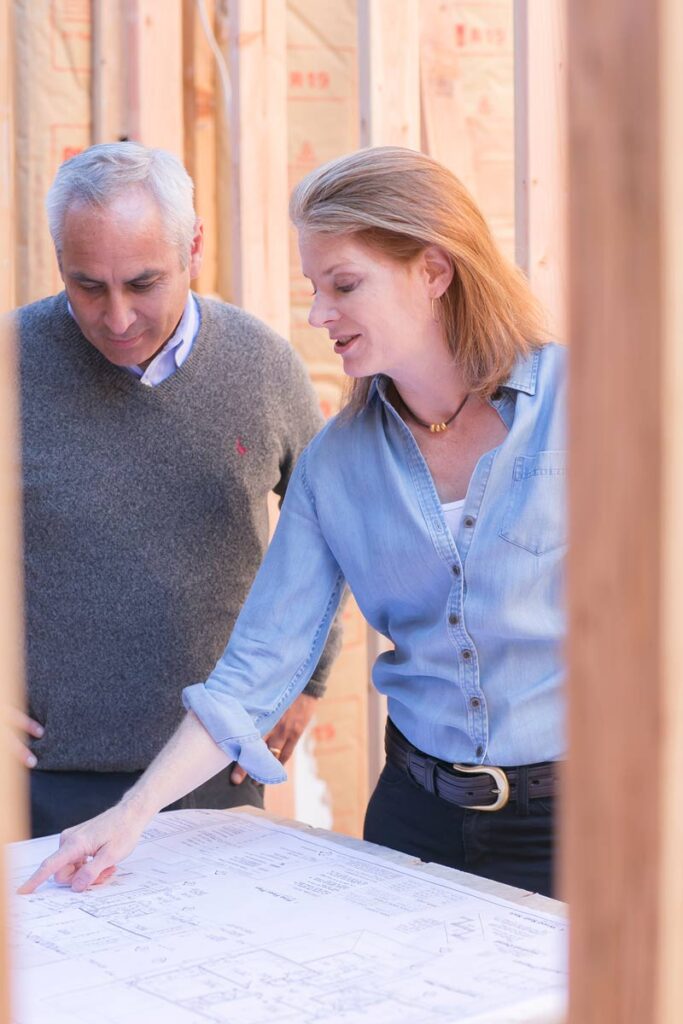 man and woman looking at kitchen blueprints
