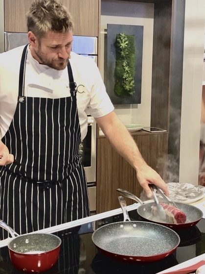 chef cooking on induction cooktop