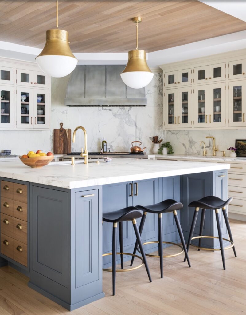blue and wood island in kitchen with stools