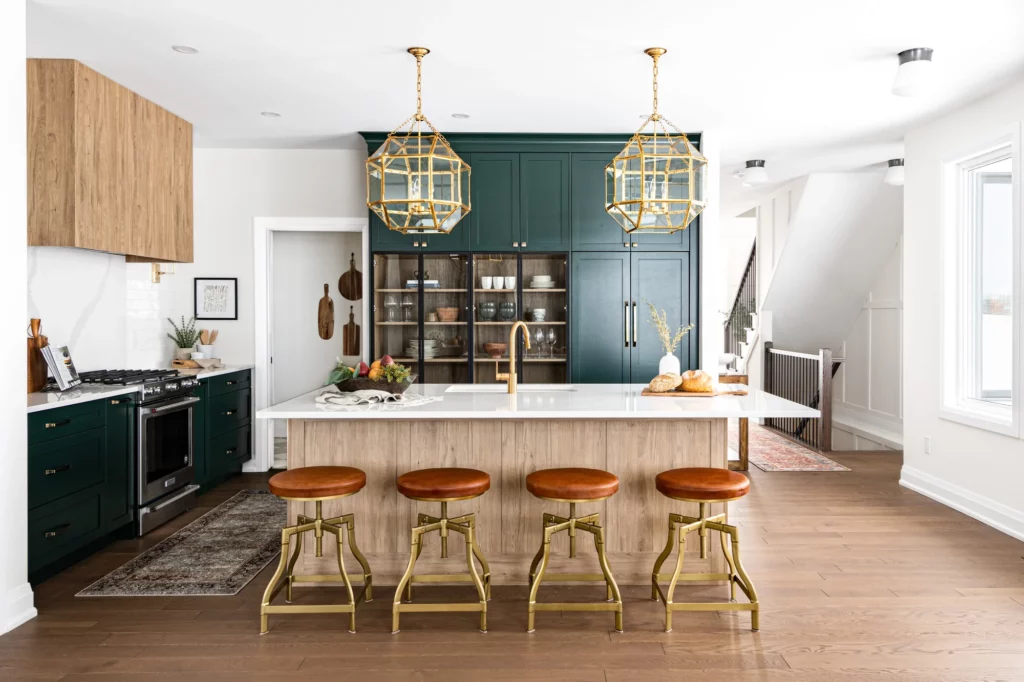green and wood kitchen with brass accents