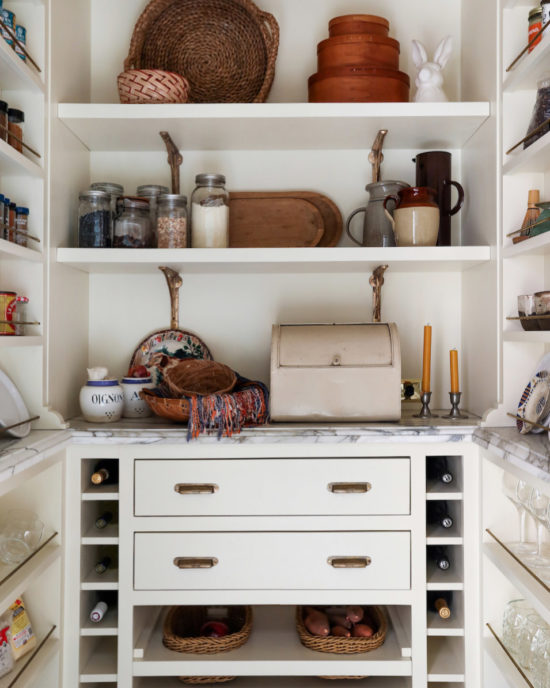 butlers pantry with shelves and cabinets