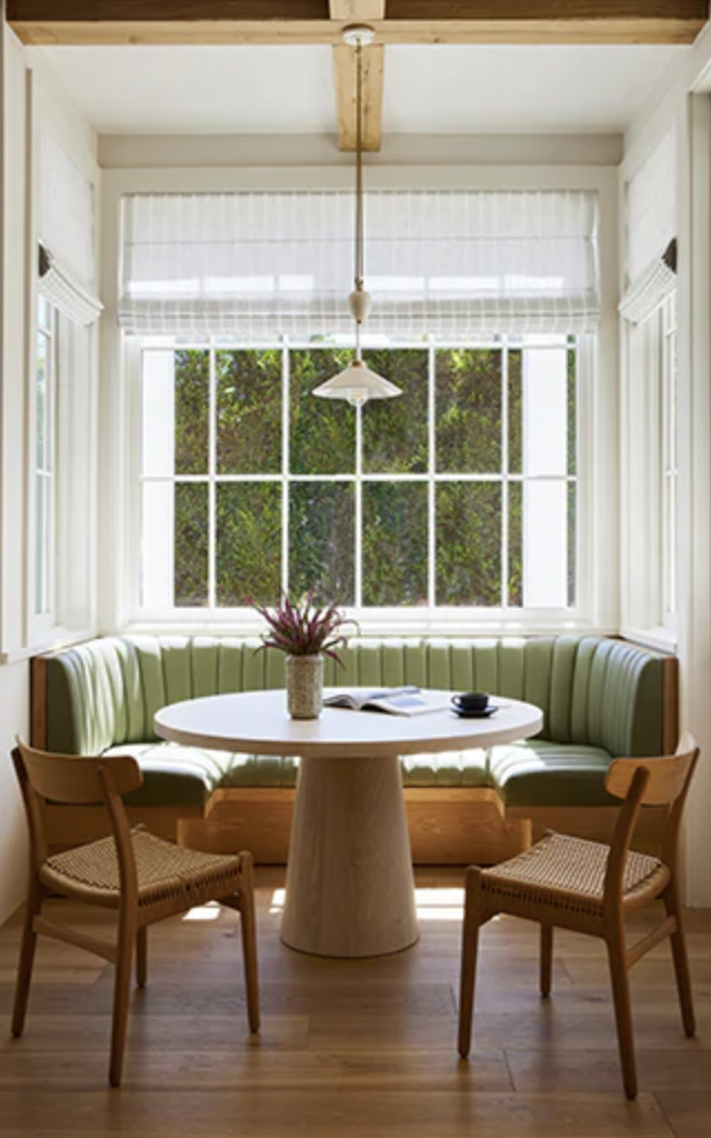 green leather banquette with table and chairs