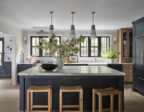 kitchen with large island and dark cabinets and light wood accents