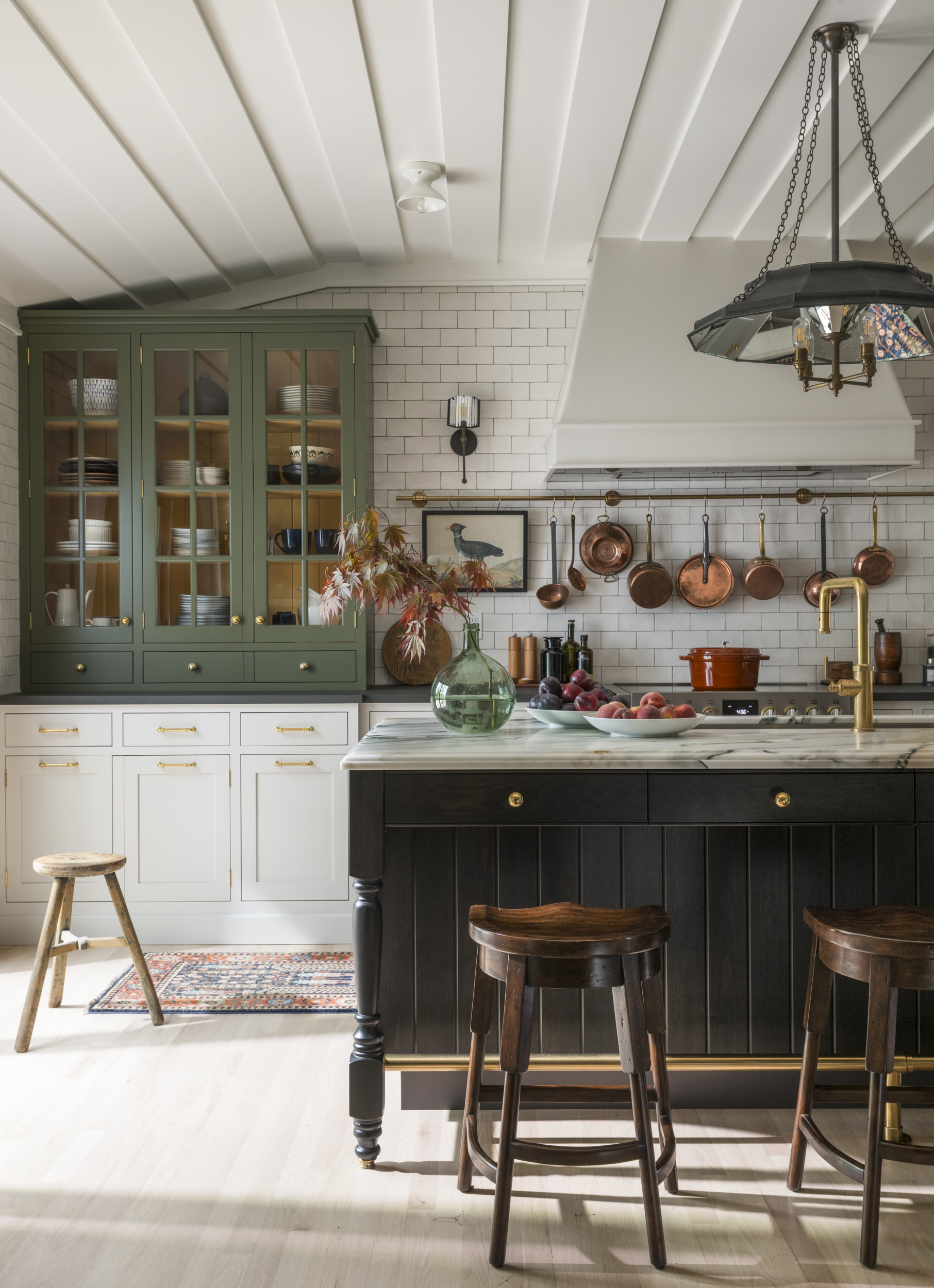 green and yellow cabinet in black and white bistro kitchen